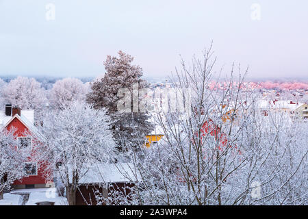 House with hoarfrost on the trees in the city Stock Photo