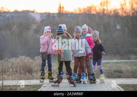 Belarus, Gomel city, April 04, 2019. Neighborhood area.A group of kids in roller skates on the street. Stock Photo