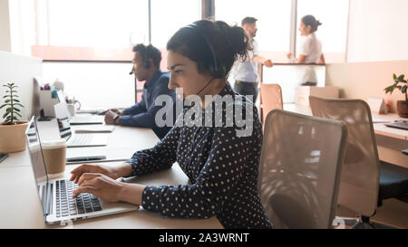 Indian woman call center operator working in customer service office Stock Photo