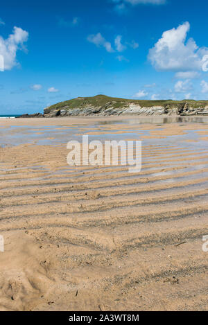 Low tide at Porth Beach with Porth Island Trevelegue Head in the background in Newquay in Cornwall. Stock Photo