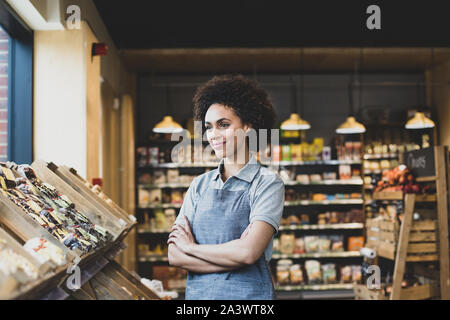 Small business owner looking out of window Stock Photo