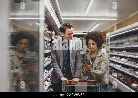 Couple choosing a ready meal in grocery store Stock Photo