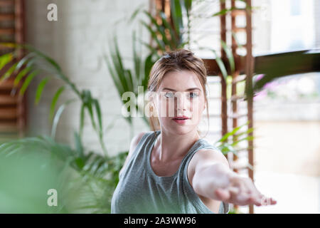 Young adult female practicing yoga Stock Photo