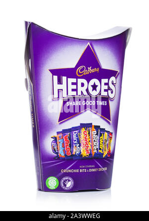 LONDON, UK - OCTOBER 10, 2019: Gift box of Heroes mix chocolate candies on white. Dairy Milk, Wispa, Twirl, Eclairs, Dinky Decker. Stock Photo