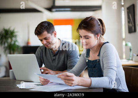 Young adult couple working on finance application together Stock Photo