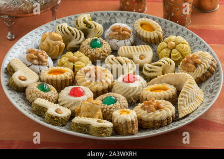 Diversity of traditional festive Moroccan cookies on a dish and tea Stock Photo