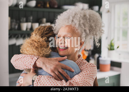 Senior adult woman hugging daughter Stock Photo