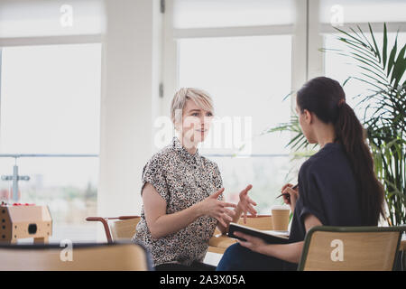 Young female businesswomen in a meeting Stock Photo