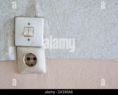 Old light switch and outlet in the apartment Stock Photo