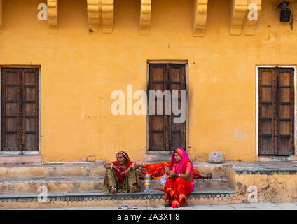 Indian women sit in Amer fort and palace, Rajasthan, Amer, India Stock Photo