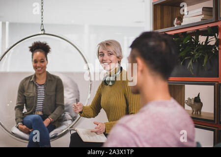 Coworkers brainstorming in a creative workspace Stock Photo