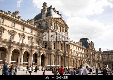 The Louvre Museum facing the Napoleon courtyard and the glass pyramid in Paris, France. Stock Photo