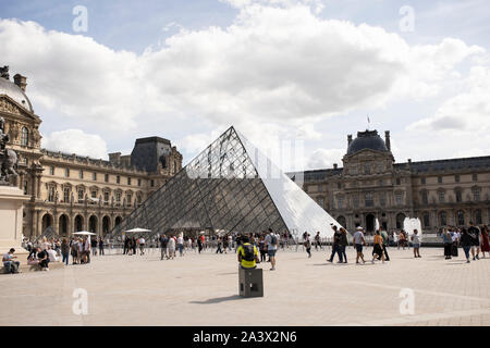 The main courtyard (Cour Napoleon) of the Louvre palace museum, with the pyramid designed by I.M. Pei, in Paris, France. Stock Photo