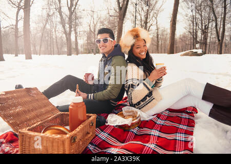 Group of millenial young adult friends enjoying wintertime and in a snow filled park Stock Photo