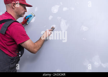 Professional painter with roller. Renovation Stock Photo