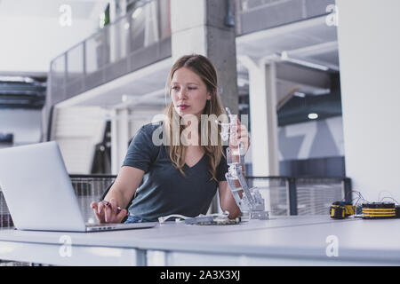 Female working on robotics Stock Photo