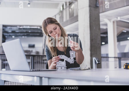 Female working on robotics Stock Photo