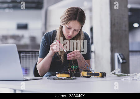 Female working on robotics Stock Photo
