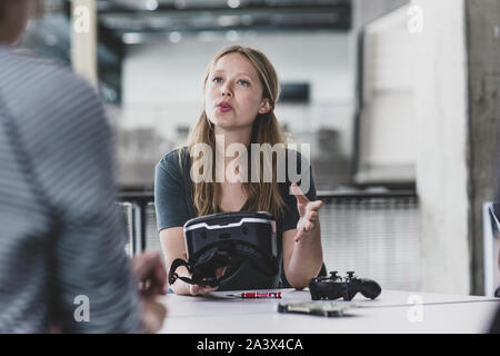 Female game designer leading a meeting Stock Photo