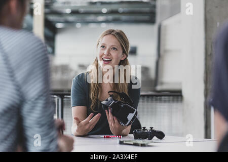 Female game designer leading a meeting Stock Photo