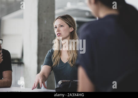 Female game designer leading a meeting Stock Photo