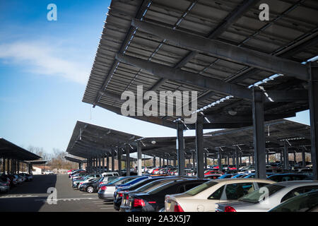 Solar photovoltaic panels in large scale parking lot arrangement. Stock Photo