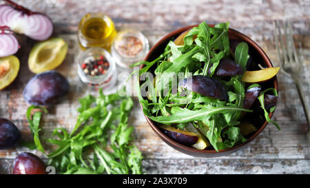 Healthy autumn salad with arugula and plum. Selective focus. Macro. Stock Photo
