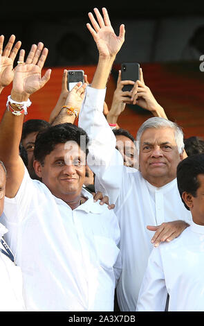 Colombo, Sri Lanka. 10th Oct, 2019. Presidential candidate of Sri Lanka's governing party Sajith Premadasa (L) and prime minister Ranil Wickeremesinghe (R) wave to supporters during their first election campaign rally in Colombo, Sri Lanka, Thursday, October. 10, 2019. Credit: Pradeep Dambarage/ZUMA Wire/Alamy Live News Stock Photo