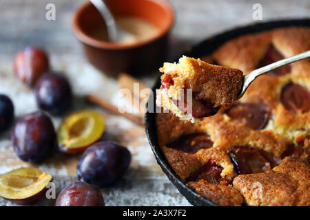 Selective focus. Slice of plum pie on a fork. Homemade American plum pie. Macro. Stock Photo