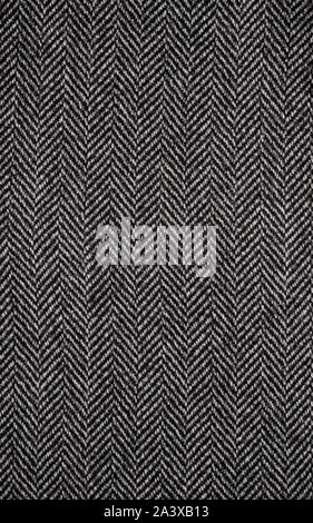 The texture of the fabric for the coat. Closeup of wool herringbone fabric. weed, Wool Background Texture. Stock Photo