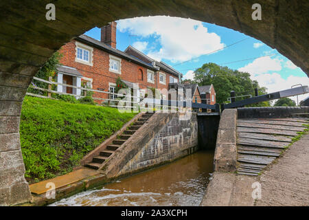 Looking under the bridge at Tyrley Wharf and locks, Tyrley, on the Staffordshire and Shropshire border, on the Shropshire Union Canal, England, UK Stock Photo