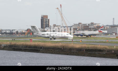 London, UK. 10th Oct, 2019. Airplanes taxi at London City Airport runway as protesters by climate activists from Extinction Rebellion threaten to shut down the airport. Credit: Amer Ghazzal/SOPA Images/ZUMA Wire/Alamy Live News Stock Photo