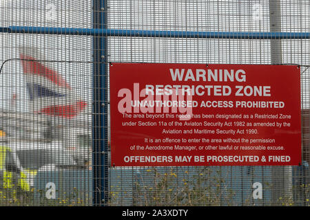 London, UK. 10th Oct, 2019. A restricted sign hangs on a fence at the London City Airport as protesters by climate activists from Extinction Rebellion threaten to shut down the airport. Credit: Amer Ghazzal/SOPA Images/ZUMA Wire/Alamy Live News