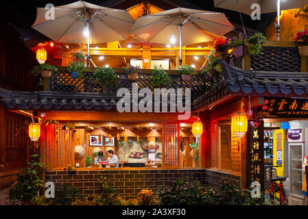 Lijiang, China - April 26, 2019: Traditional Naxi restaurants in Lijiang Old Town at night. Old town is an UNESCO World Heritage Site Stock Photo