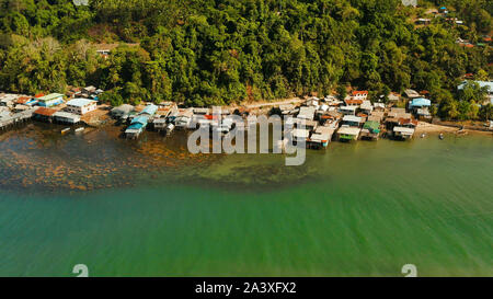 Village of stilt houses built over the sea, top view. City and port on Balabac Island, Palawan, Philippines. Stock Photo