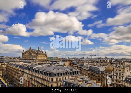 Paris skyline on a bright spring day with moody clouds from the Printemps rooftop with a great view of Opera Garnier Stock Photo