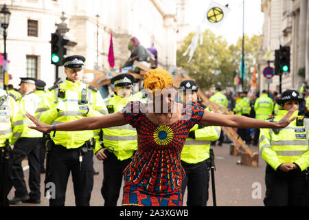 London, UK. 9th October 2019. Protesters on corner of Birdcage Walk and Horse Guards Road, Westminster, during the Extinction Rebellion two week long protest in London. Credit: Joe Kuis / Alamy News Stock Photo