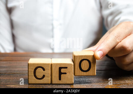 A man makes the word acronym abbreviation CFO. Chief Financial Officer. Financial management in business and company. Risk. Development and growth. Ap Stock Photo