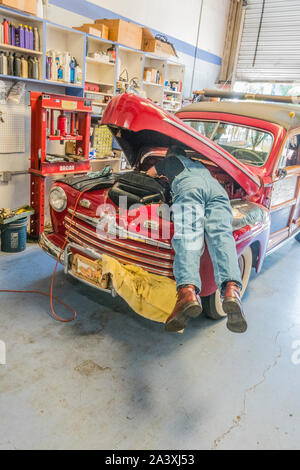 Car repairman under hood Stock Photo