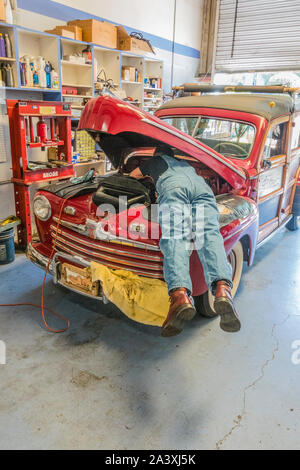Car repairman under hood Stock Photo