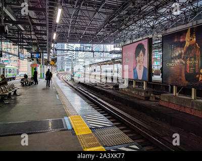 Tokyo, Japan - February 23, 2017 : People wait on the platforms at the Shimbashi Train Station, Tokyo, Japan Stock Photo