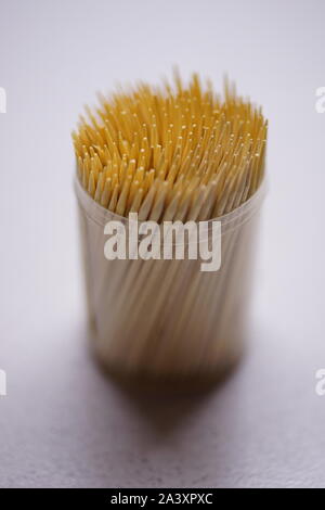 bamboo toothpicks in a round plastic box on the table Stock Photo