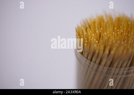 Bamboo toothpicks in a round plastic box close-up. Oral care. Copy space. Stock Photo