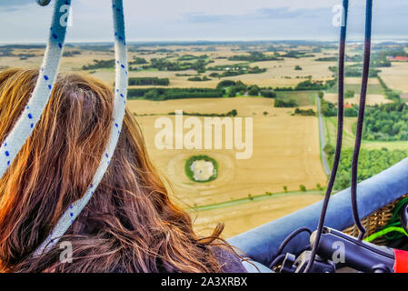 Woman admires the View over Sjaelland from an hot air balloon, Denmark, August 14, 2017 Stock Photo