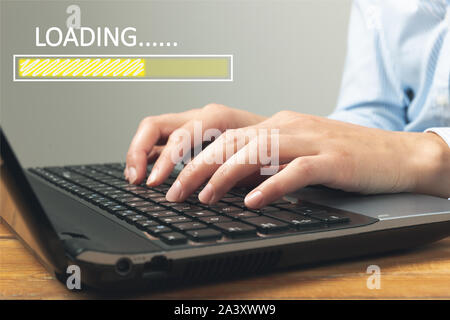 Loading concept with woman using a laptop in a home office. Freelance, online business, start up business Stock Photo