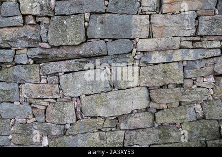 Quarry stone wall consisting of stones of various sizes, Stock Photo
