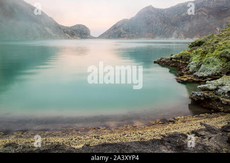 Acid lake inside the crate of Mount Ijen, a volcano in East Java, Indonesia. Tranquil turquoise water. Stock Photo