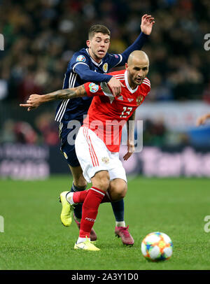 Russia’s Fedor Kudryashov (right) and Scotland's Ryan Christie battle for the ball during the UEFA Euro 2020 qualifying, group I match at the Luzhniki Stadium, Moscow. Stock Photo