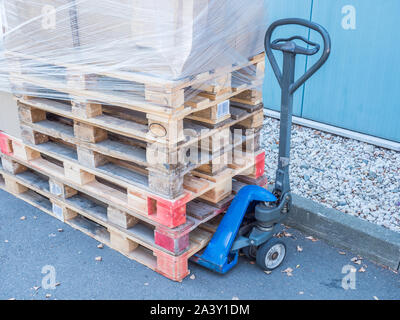 stacked wooden pallets logistic with lift truck Stock Photo