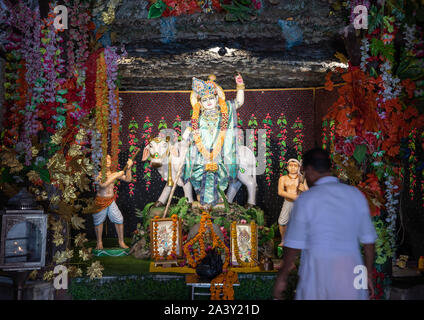 Indian man praying in a Giriraj dharan mandir, Rajasthan, Dausa, India Stock Photo